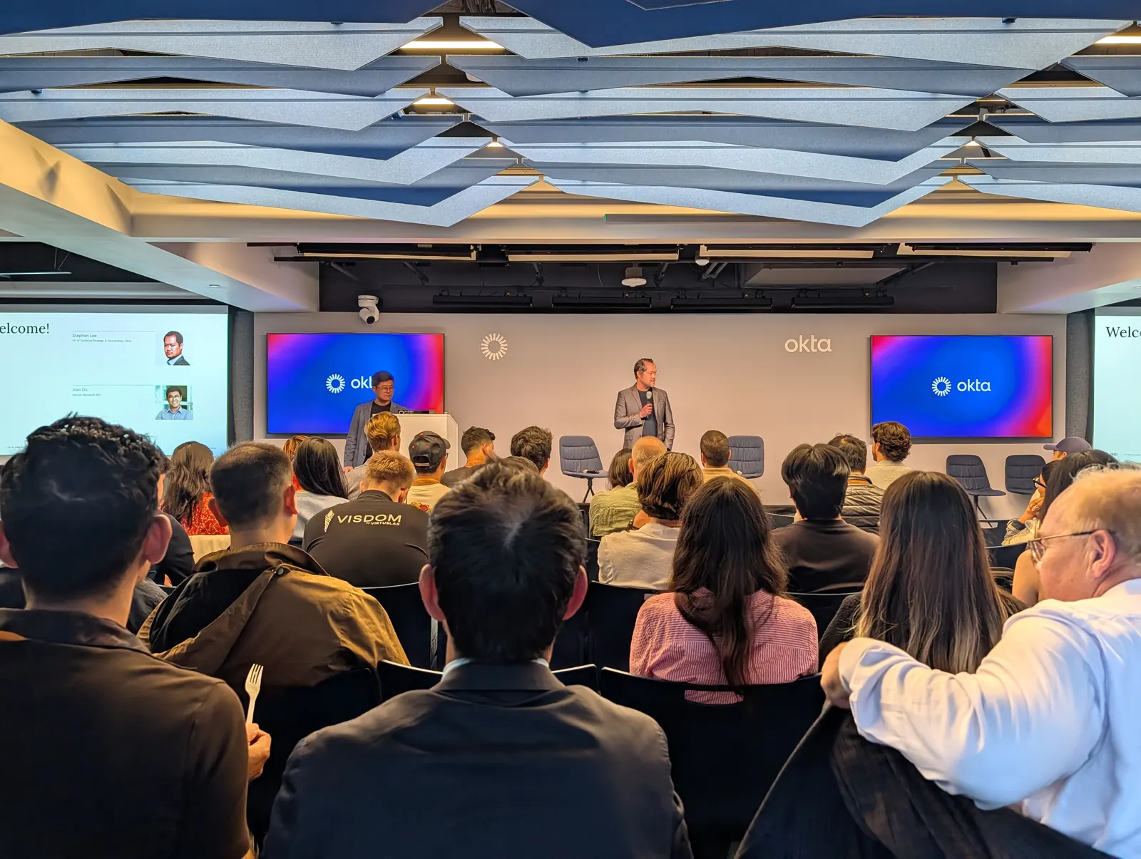 Audience watching a presentation at Okta headquarters