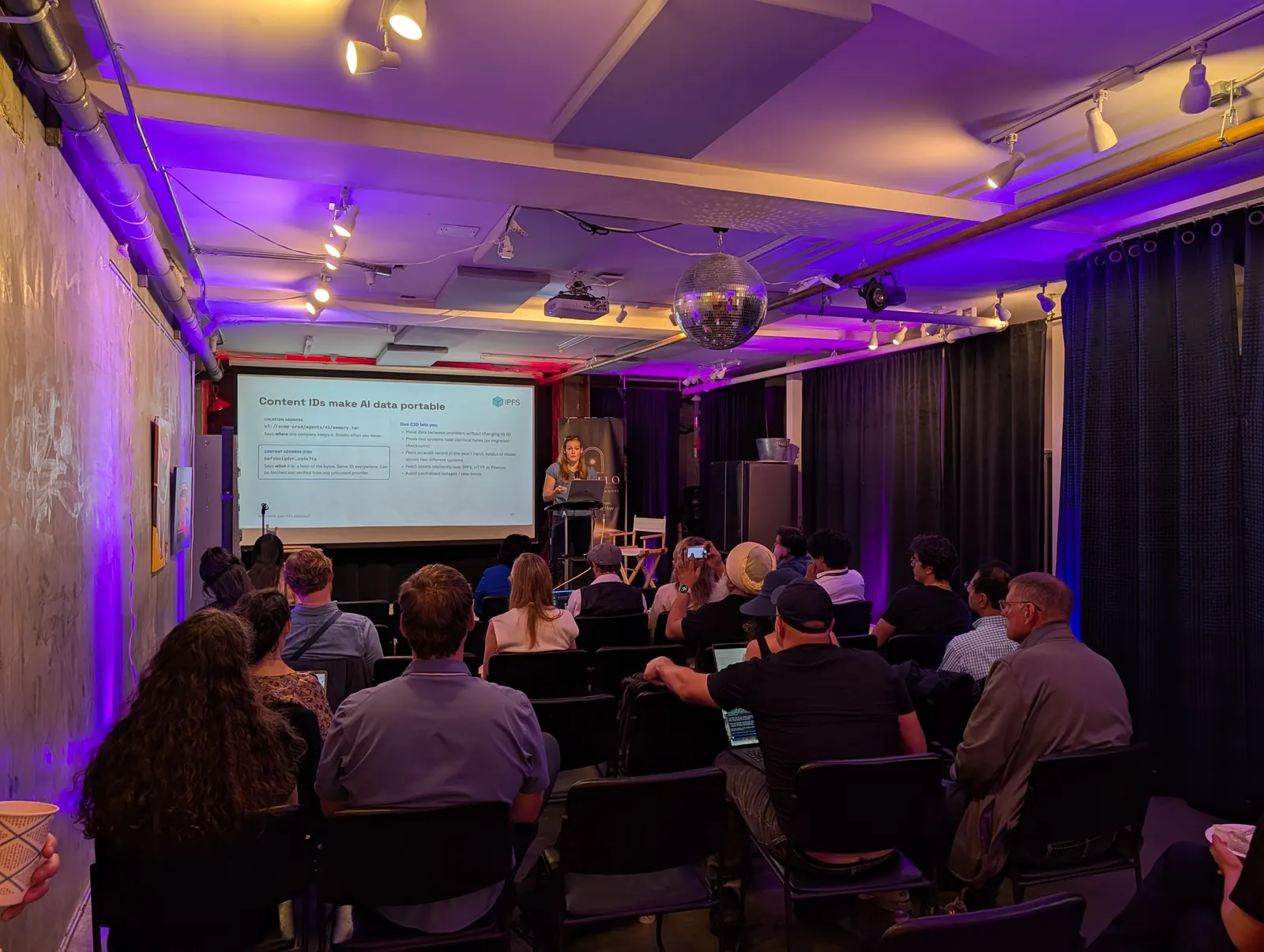 Speaker presenting about portable AI data at Open Source x Sovereign AI