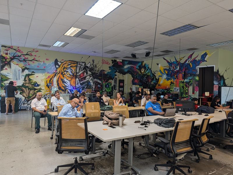 The StartupA2Z audience seated beside Hacker Dojo’s mural during the September 15 session